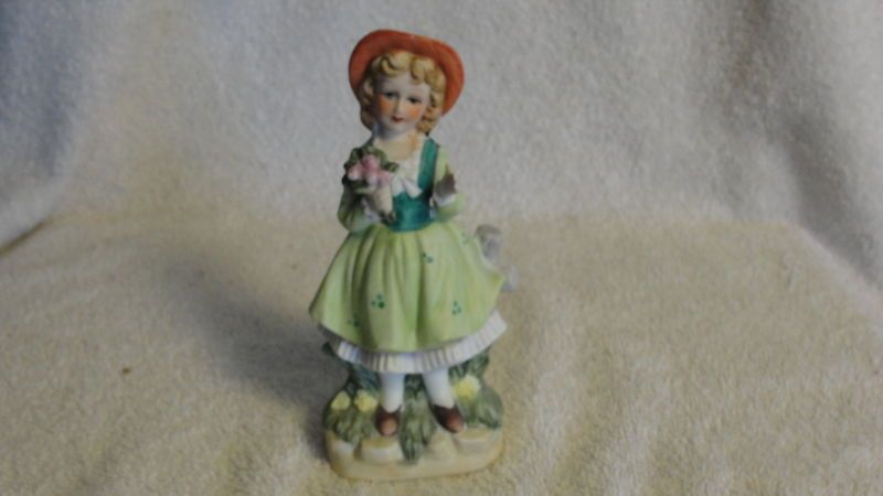 LADY WITH FLOWERS LEANING ON A FENCE PAINTED FIGURINE  