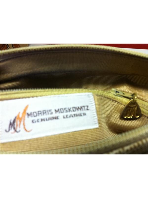   on the outside as Lizard skin, Gold MM symbol attached to zipper